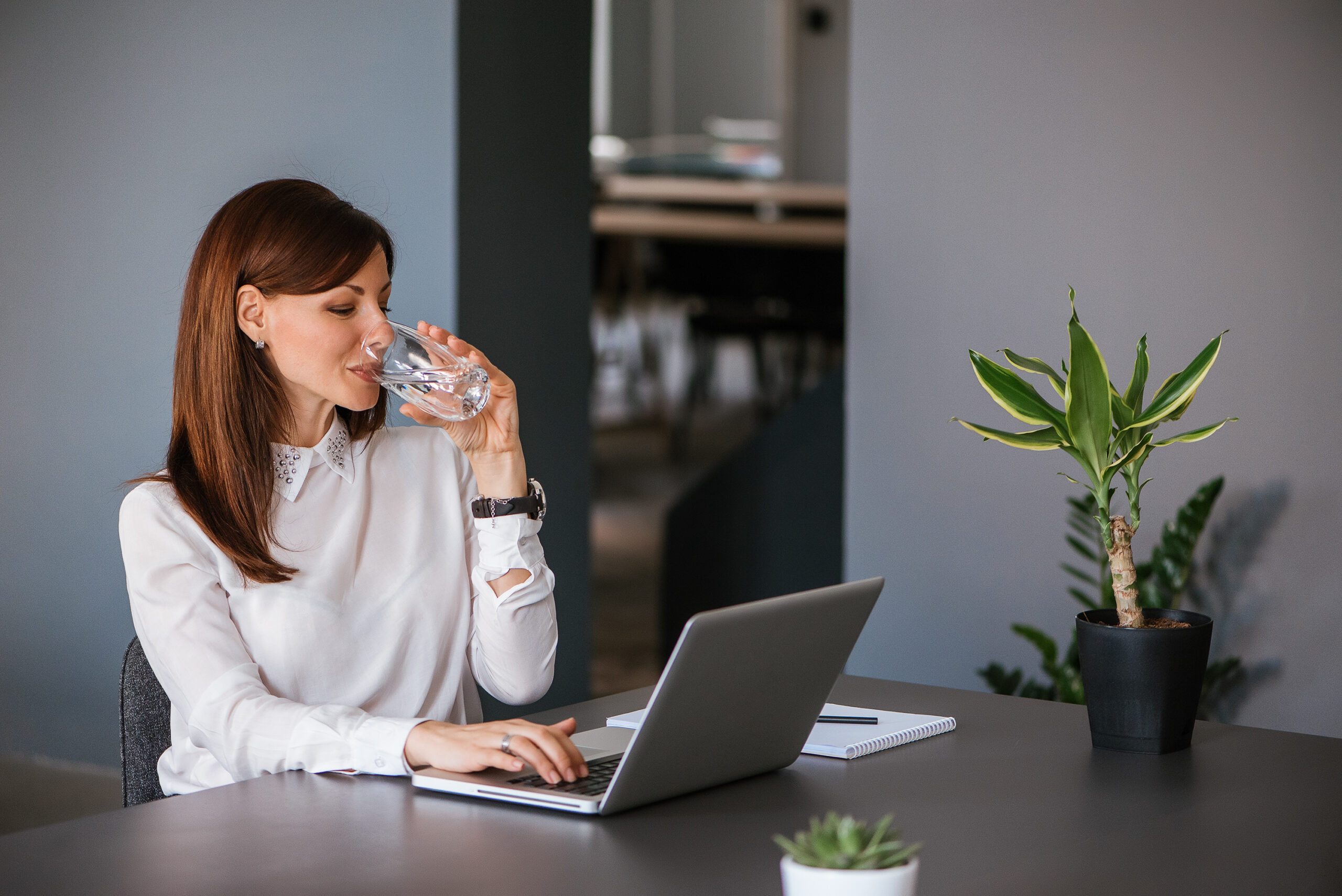 Stay,Hydrated.,Pretty,Young,Woman,In,The,Office,Drinking,Water